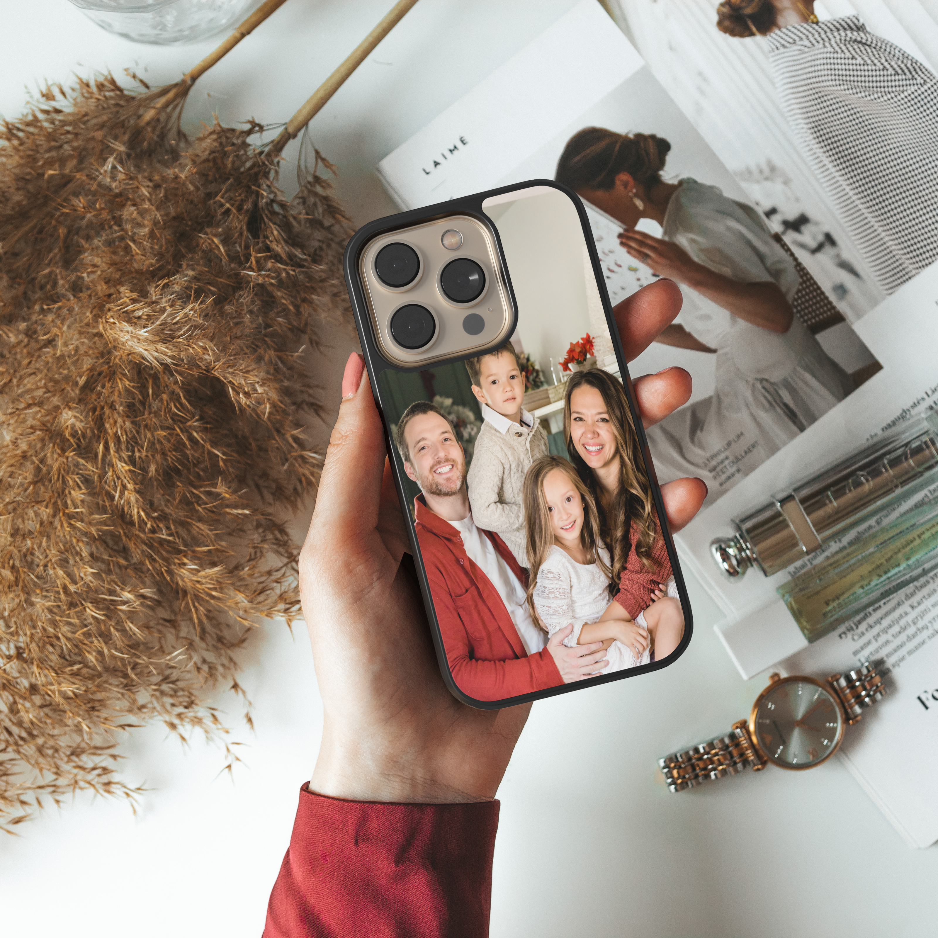 Hand holding a personalized family photo phone case, custom design featuring family members.