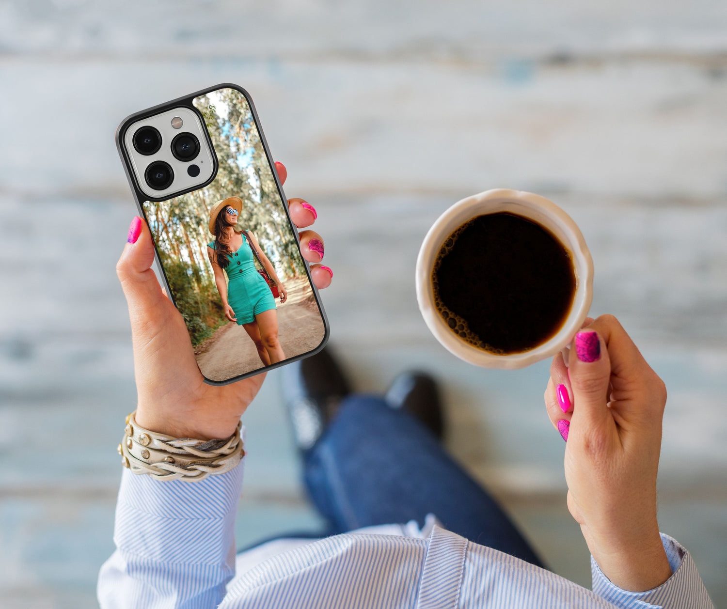 Woman's hand holding a custom phone case with a selfie picture design, while holding a cup of coffee in the other hand, showcasing personalized phone accessory style.